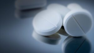 Close up on acetaminophen pills on a steel table