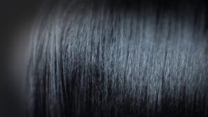 Close up of Black hair that has been treated with a chemical hair relaxer