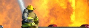 firefighter working to put out a large fire