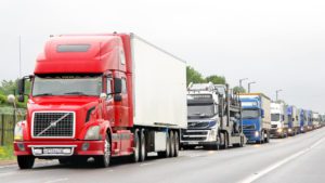 Commercial Trucks driving on the the highway representing a truck accident lawsuit case settlement